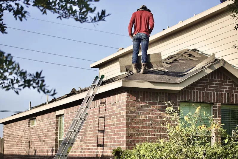Professional roofer working on a residential roof in Bluefield